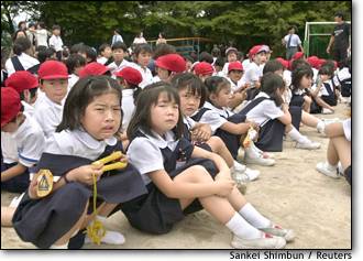 Image: Schoolchildren weep on the grounds of Ikeda elementary school in Osaka, Japan
